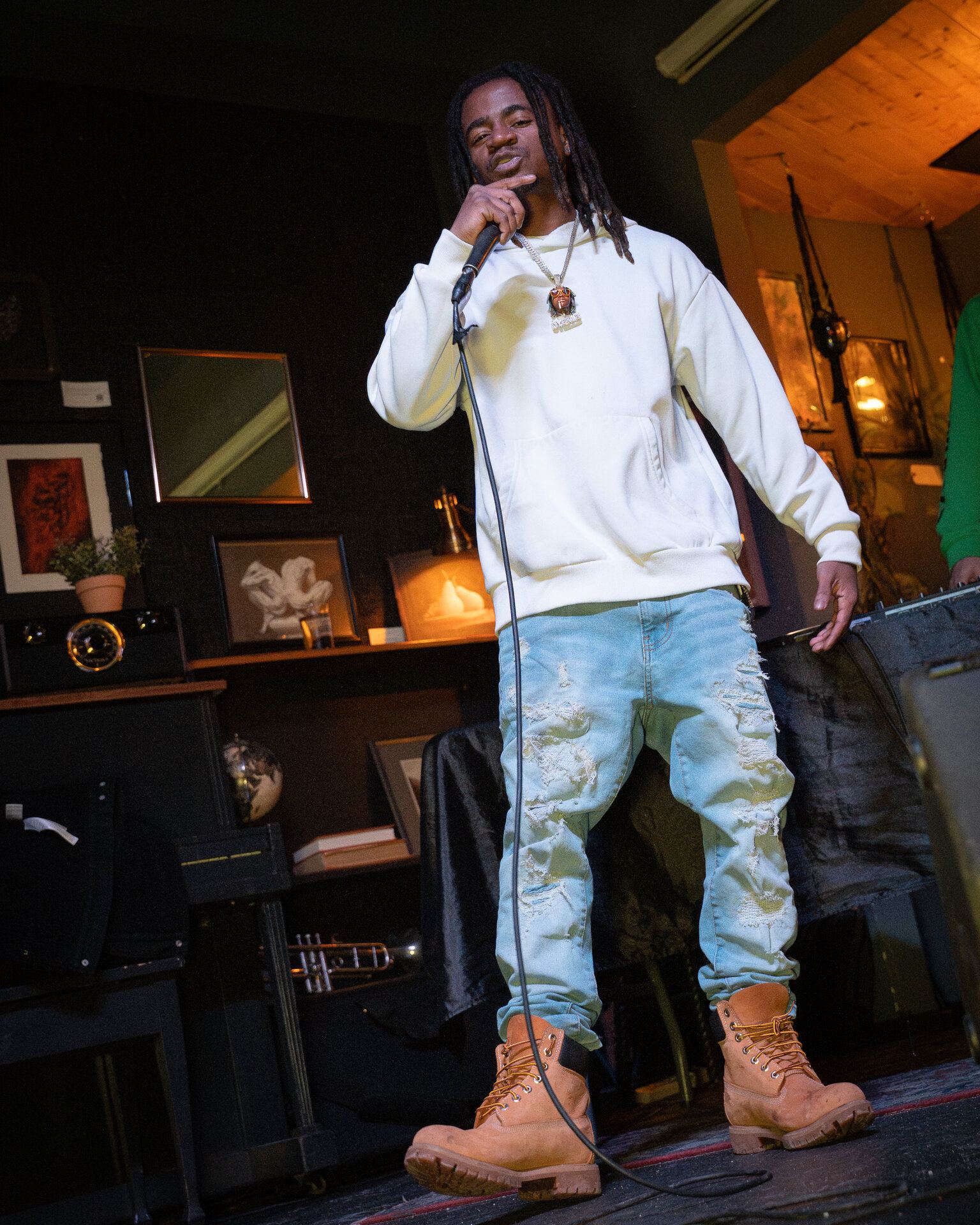 Man performing into a microphone at a Saskatoon gallery event