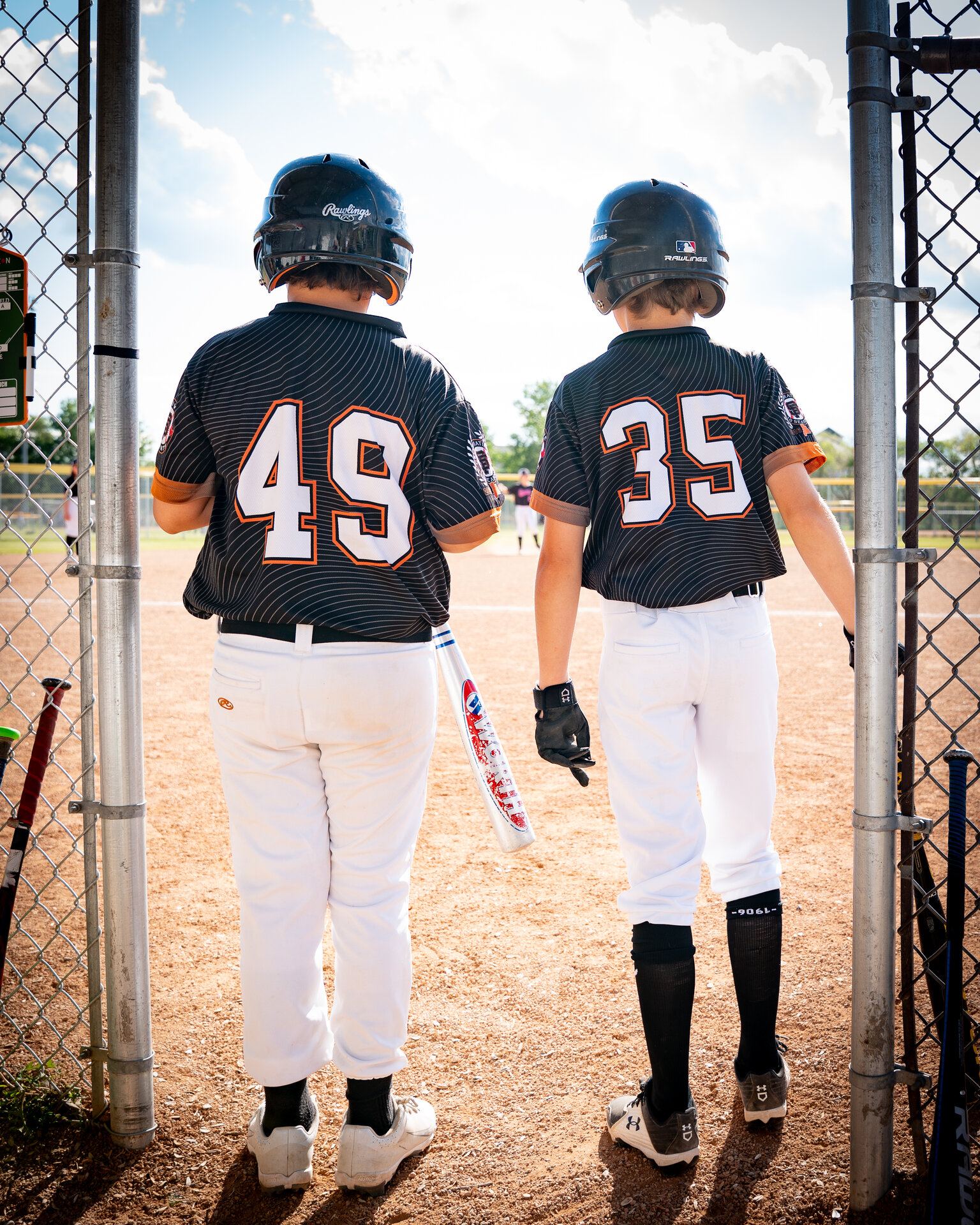 Two young baseball players at a fence, Saskatoon family photos